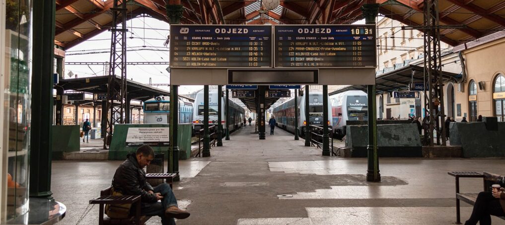 In Prague station a man sits reading a newspaper