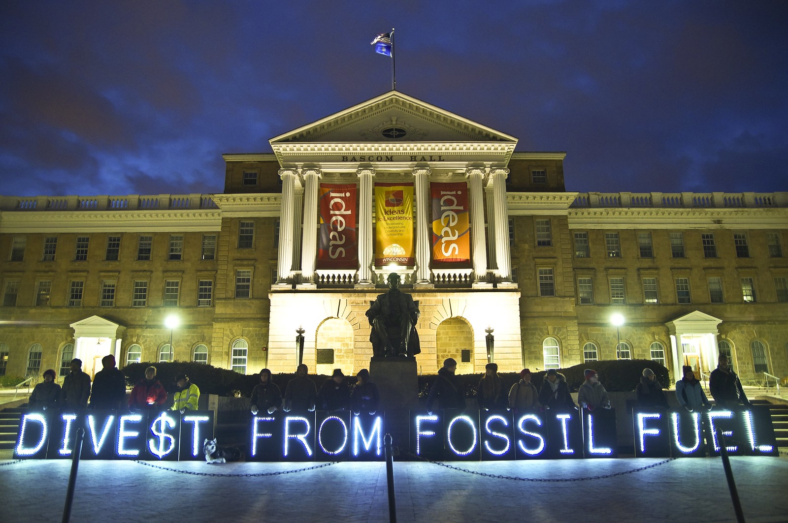 Building lit with divest from fossil fuel sign
